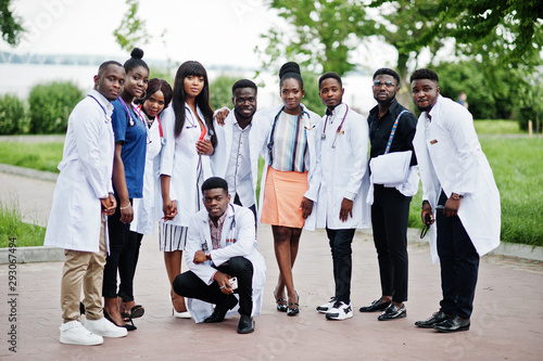 Fototapeta Naklejka Na Ścianę i Meble -  Group of african medical students posed outdoor in white lab coats.