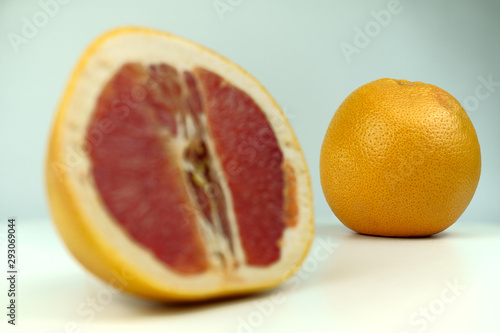 Grapefruit with grapefruit slice isolated on white background close up.