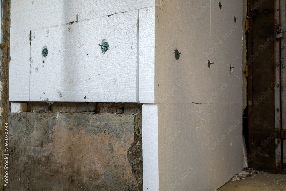 Insulation work of house walls with styrofoam sheets. Insulation work of house walls with styrofoam sheets.
