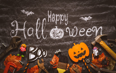 Happy Halloween day with construction DIY handy tools on black chalk board background concept. Flat lay Top view.