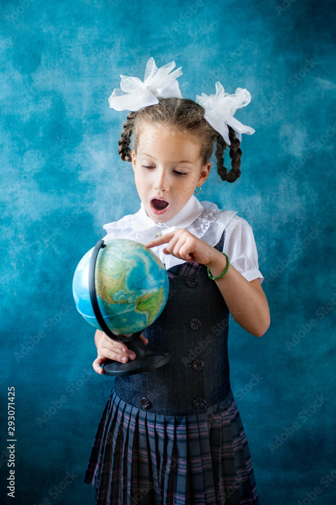 Cute little schoolgirl hold world globe Cute little schoolgirl hold world globe