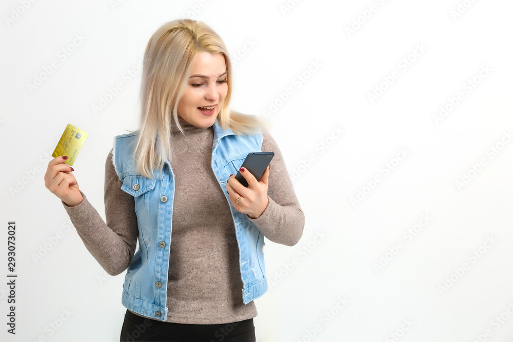 Lady buying online with a credit card and smart phone isolated white background Lady buying online with a credit card and smart phone isolated white background
