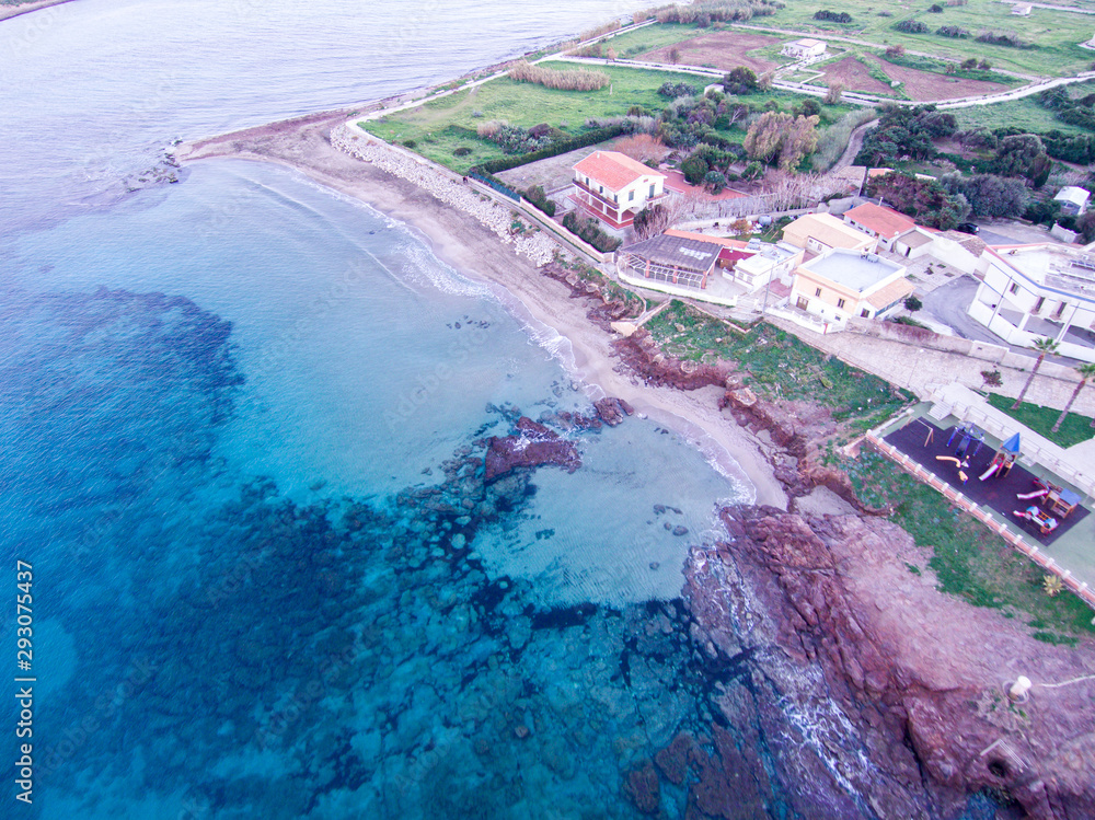 Wonderful aerial view at sunset of the coastline of Portopalo, a town in the southern Sicily. The shot is taken during a beautiful sunny day at sunset