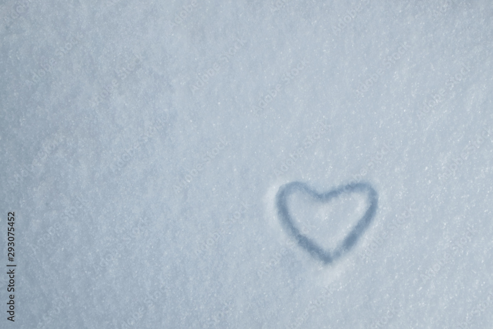 Drawing of heart on the background of fresh snow texture in blue tone. Merry Christmas or Valentine's Day Concept. Copy space, high resolution product