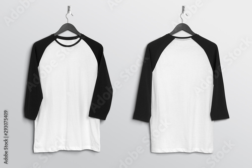 Obraz na plátne Front back of white and black plain 3 quarter sleeve raglan t shirt hanging on w