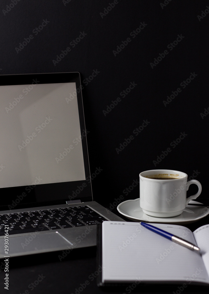 Office desk table with laptop, cup of coffee and other supplies. With copy space Office desk table with laptop, cup of coffee and other supplies. With copy space