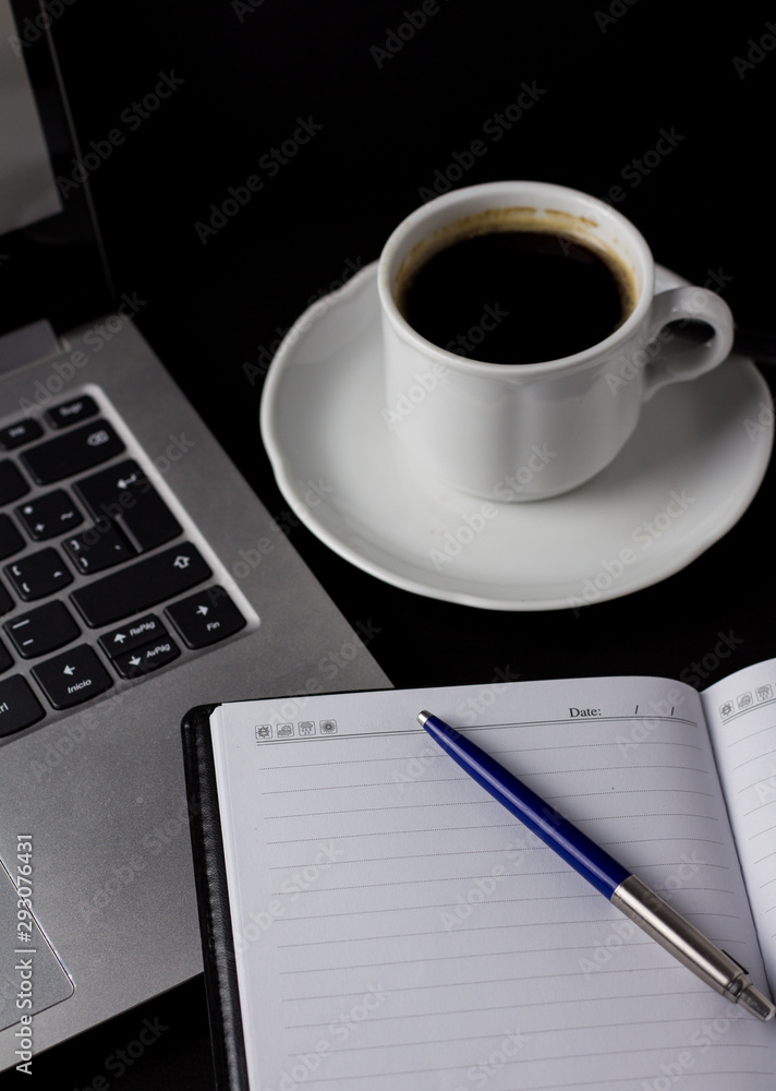 Office desk table with laptop, cup of coffee and other supplies. With copy space Office desk table with laptop, cup of coffee and other supplies. With copy space