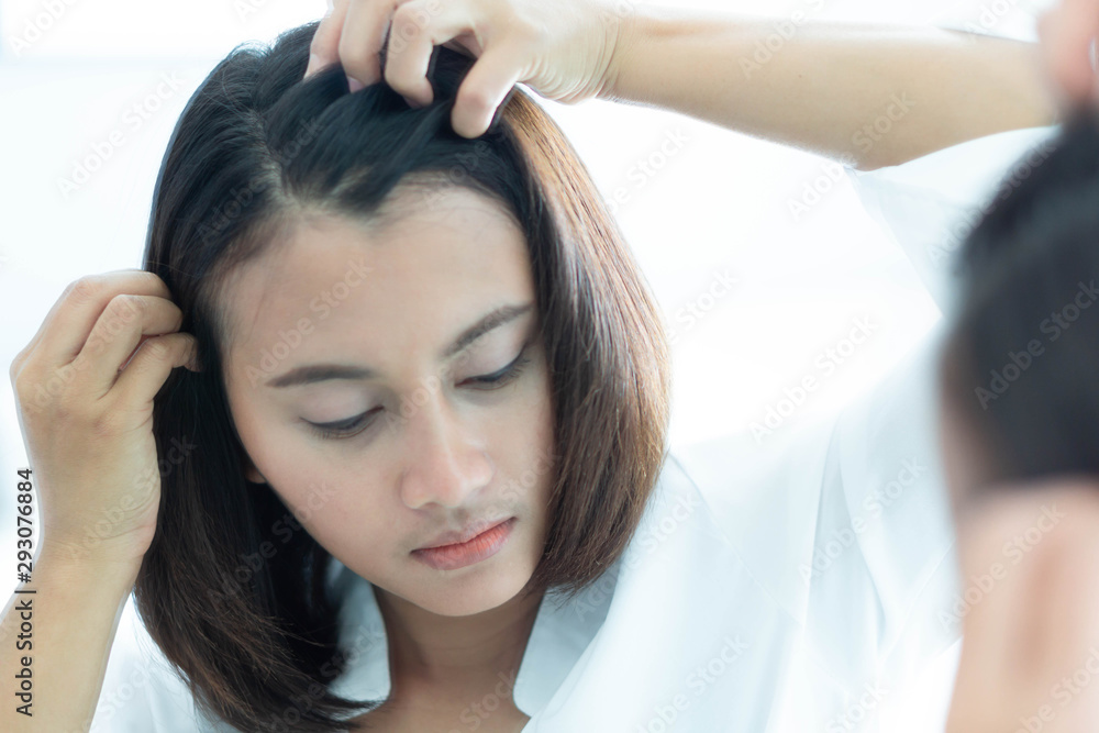 Naklejka premium Woman looking reflection in the mirror serious hair loss problem for health care shampoo and beauty product concept