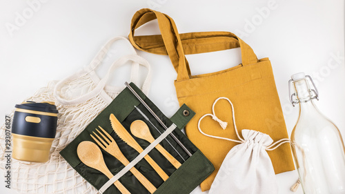 Eco bags with bamboo cutlery, reusable coffee mug and water bottle.