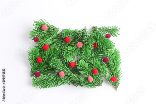 Creative Christmas composition on a white background. spruce branches decorated with red balls. flat lay, top view
