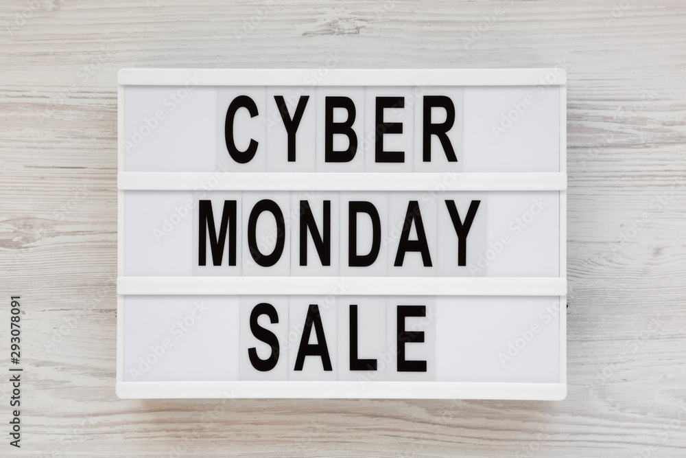 'Cyber monday sale' words on a lightbox on a white wooden surface, top view. Overhead, from above, flat lay. 'Cyber monday sale' words on a lightbox on a white wooden surface, top view. Overhead, from above, flat lay.