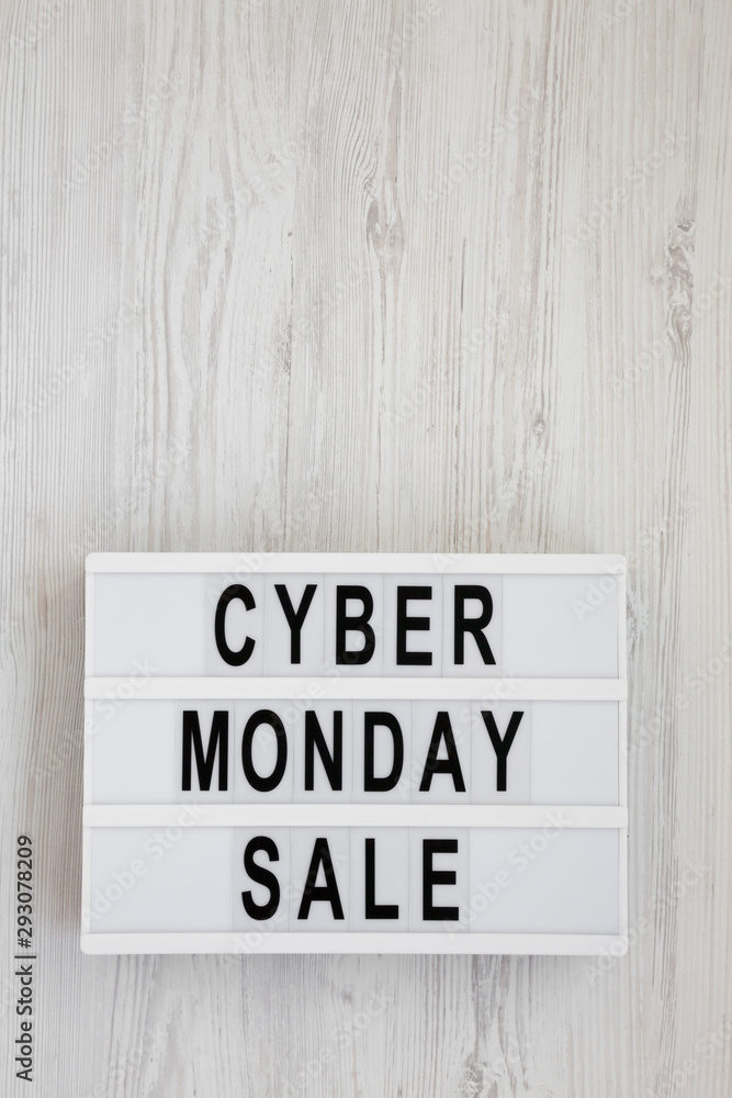 'Cyber monday sale' words on a lightbox on a white wooden background, top view. Overhead, from above, flat lay. Copy space. 'Cyber monday sale' words on a lightbox on a white wooden background, top view. Overhead, from above, flat lay. Copy space.
