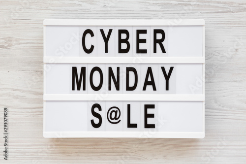 'Cyber monday sale' words on a modern board on a white wooden surface, top view. Overhead, from above, flat lay. Closeup.