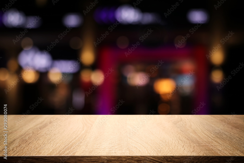 background of wooden table in front of abstract blurred restaurant lights background of wooden table in front of abstract blurred restaurant lights