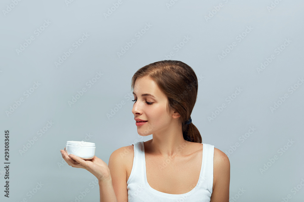 Beauty Face Skincare.Beautiful Young Woman with Clean Fresh Skin Holding Bottle. Beauty face care. Facial treatment. Cosmetology.Beauty and spa. Beauty Face Skincare.Beautiful Young Woman with Clean Fresh Skin Holding Bottle. Beauty face care. Facial treatment. Cosmetology.Beauty and spa.