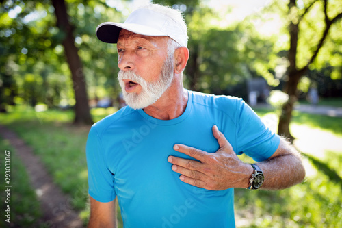 Fototapeta Naklejka Na Ścianę i Meble -  Mature man exercising outdoors to prevent cardiovascular diseases and heart attack