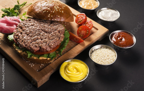 Beef burger with ready to be served sauces
