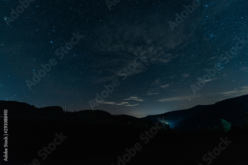 milky way rise in dark forest at night