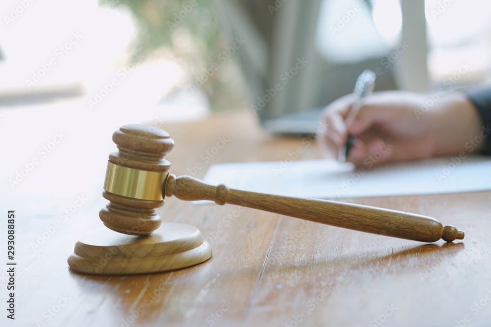 Legal counsel presents to the client a signed contract with gavel and legal law. justice and lawyer concept . Legal counsel presents to the client a signed contract with gavel and legal law. justice and lawyer concept .