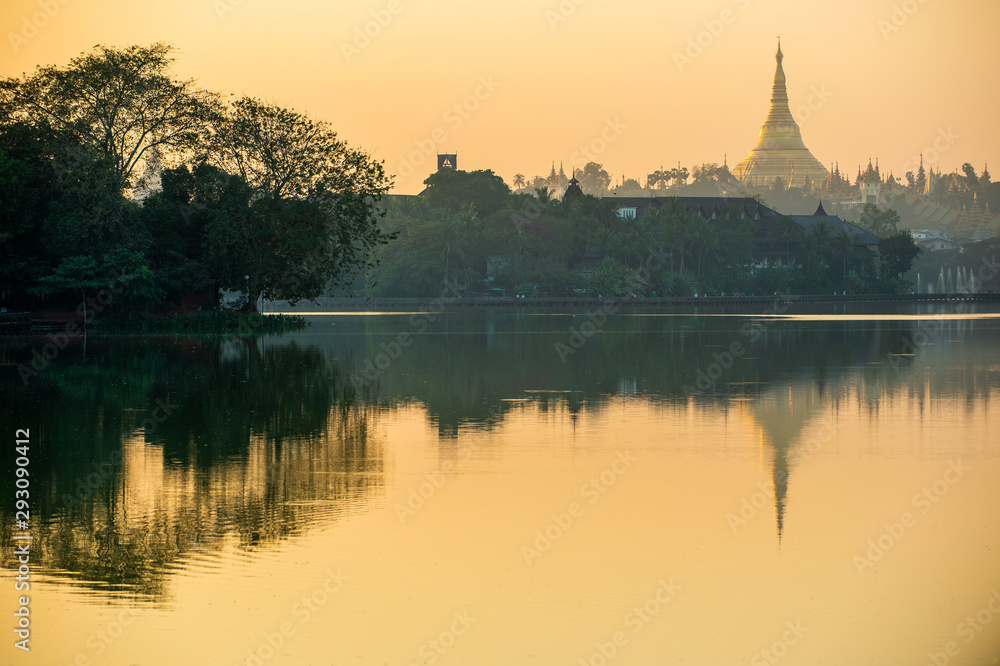 Kandawgyi Lake is one of the two major lakes in Yangon, Myanmar, located east of the Shwedagon Pagoda, reflected in the water in the evening. The sky is beautiful orange.