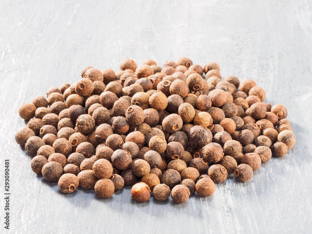 Allspice (Jamaica pepper) on grey background Allspice (Jamaica pepper) on grey background