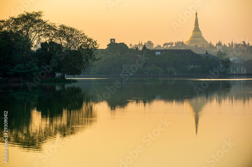 Kandawgyi Lake is one of the two major lakes in Yangon, Myanmar, located east of the Shwedagon Pagoda, reflected in the water in the evening. The sky is beautiful orange. © Lowpower