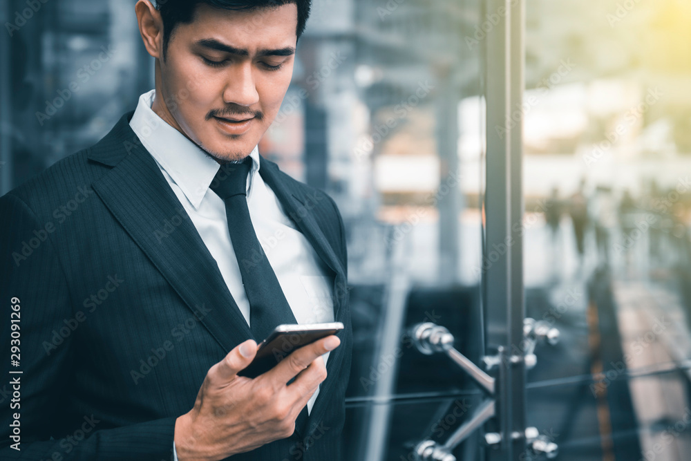 Young attractive business man using smartphone,concept of business, technology, social media etc. Young attractive business man using smartphone,concept of business, technology, social media etc.