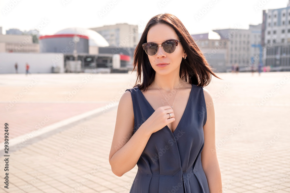 Elegant woman in evening dress on a walk in european streets. Sunny, summer weather. Copy space