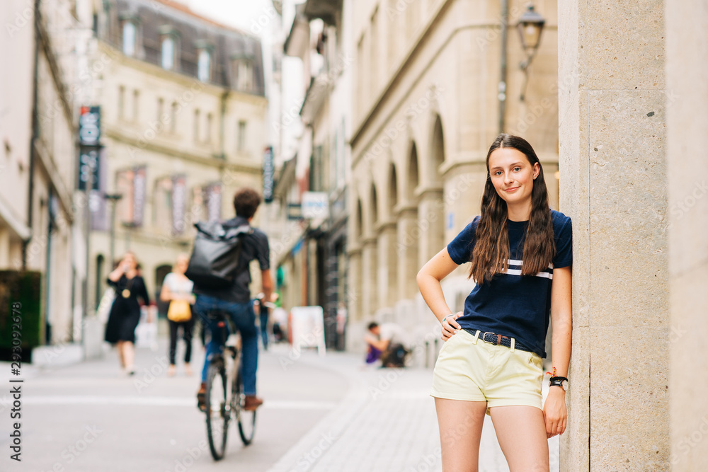 Outdoor portrait of pretty teenage girl on the city street