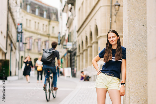 Outdoor portrait of pretty teenage girl on the city street