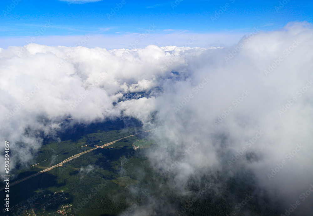 Obraz premium Clouds above the ground view from an airplane as a background