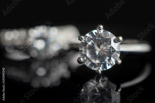 Jewelry wedding diamond rings on black background with reflection