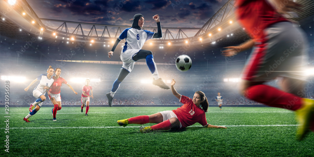 Female muslim soccer player in hijab shows exciting play during the