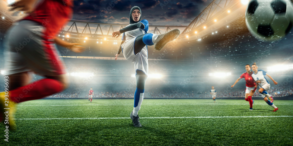 Female muslim soccer player in hijab shows exciting play during the