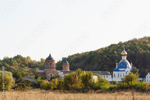 Old christian church with a blue buck photo