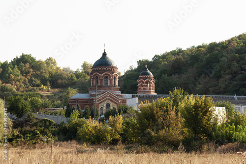 Old christian church with a blue buck photo