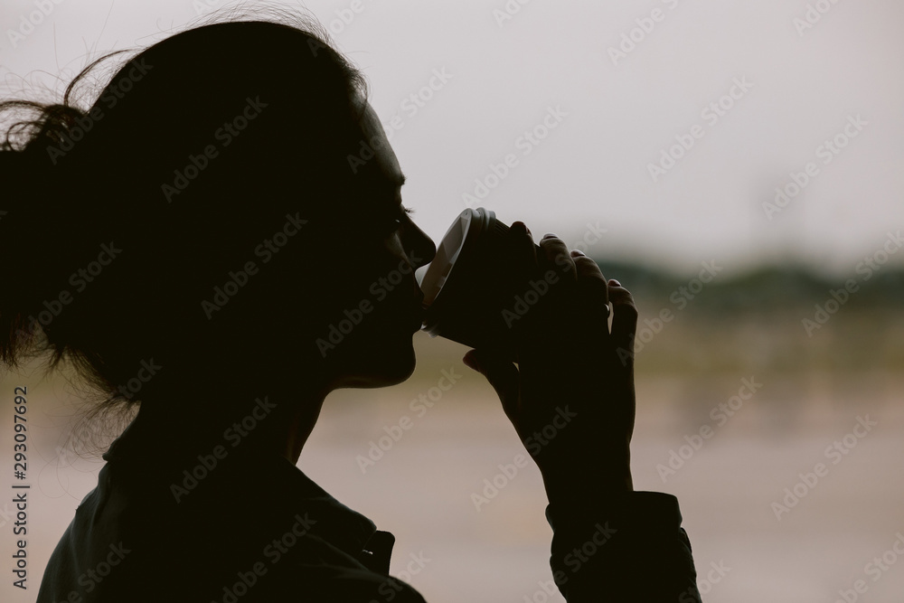 silhouette of woman waiting for flight aircraft. Airline passenger girl drinks coffee