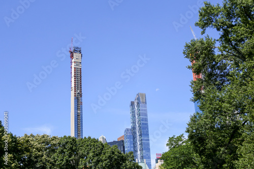 view from central park of modern skyscraper construction 