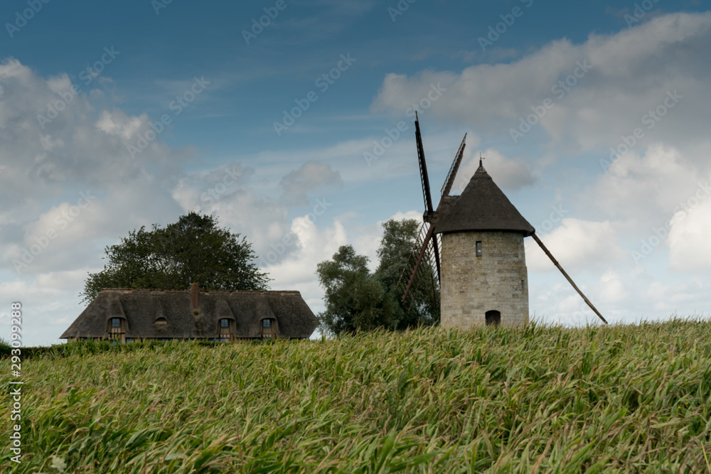 view of the historic windmill Moulin de Pierre and miller's house in Hauville in Normandy view of the historic windmill Moulin de Pierre and miller's house in Hauville in Normandy