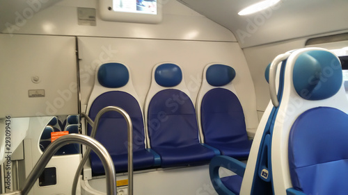 Blue seats in a beige electric train. Have a good weekend.