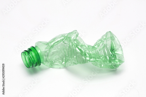 Single empty green plastic bottle on white background. Waste recycling concept. Garbage. Isolation on white.	