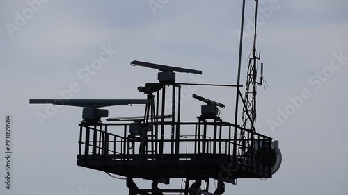 Spinning antennas of a navigation radar. Military communications facility.