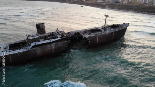 Raising up above Evanghelia shipwreck stranded on the black sea at Costinesti, after sunset photo