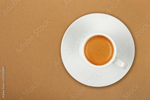 Full white espresso coffee cup over brown