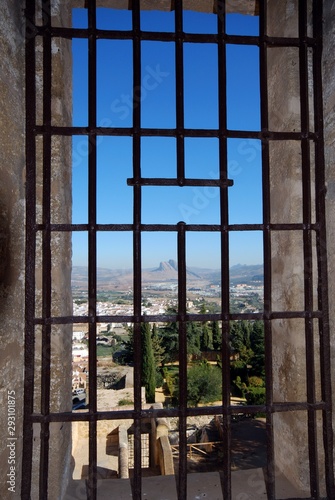 Lovers mountain seen through metal grill in castle tower (torre del homenaje), Antequera, Spain.