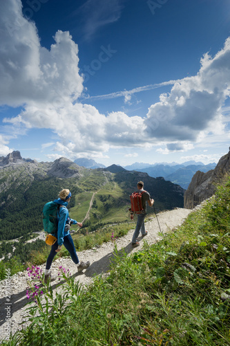 mountain guide and blonde woman client returning from a climb in the Italian Dolomites
