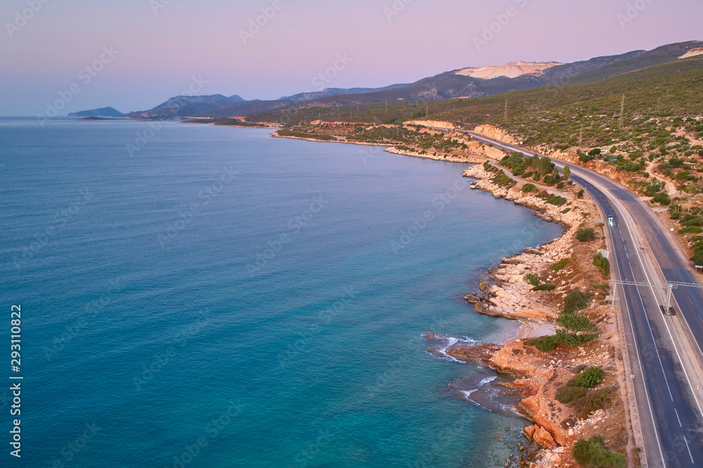 Sea, hills and asphalt motorway in the morning. Aerial view Sea, hills and asphalt motorway in the morning. Aerial view