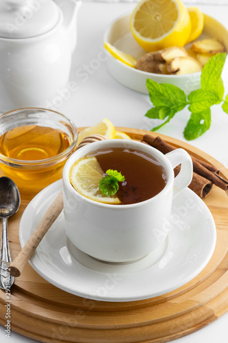 Cup tea with lemon and honey on a white background. Hot tea cup isolated, top view. Autumn, fall or winter drink. Copy space.