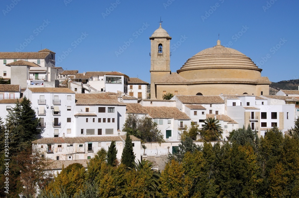View of San Antonio church and whitewashed town buildings, Montefrio, Spain.