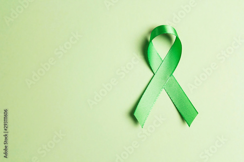 World mental health day concept. Green awareness ribbon with copy space for text .